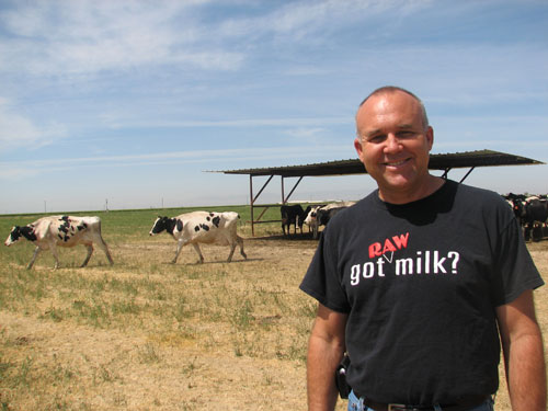 
                Dairyman Mark McAfee models a t-shirt promoting raw milk in front of his cows at Organic Pastures Dairy.
                                    (Sasha Khokha)
                                