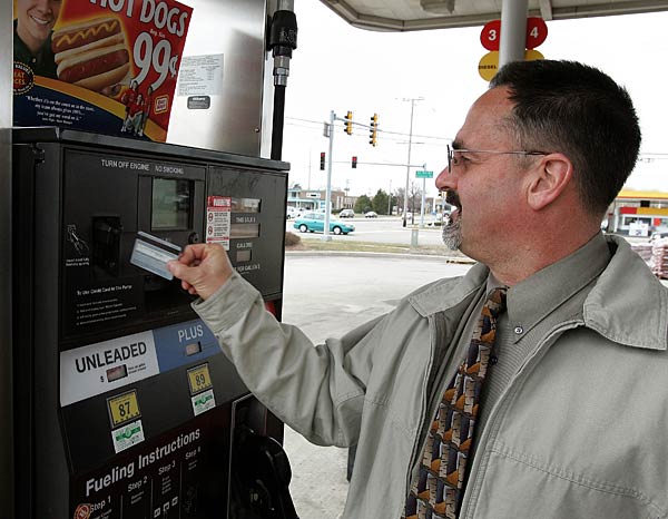 
                A customer uses his credit card to pay for gas.
                                    (Tim Boyle/Getty Images)
                                