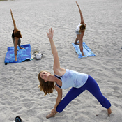 Floridians do yoga on the beach. 