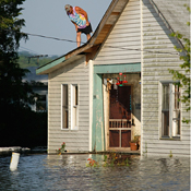 John Watson stands on roof of his flooded house 