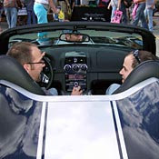 Two men talk while sitting in a Saturn Sky 
