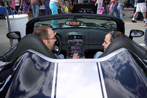 
                Two men talk while sitting in a Saturn Sky at Detroit's Motor City Pride festival, where General Motors sponsored a gay speed-dating event.
                                    (Kyle Norris)
                                