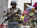An Iraqi policeman stands guard