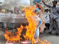 Activists of Islami Jam torch US and Israeli flags