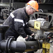 Oil worker adjusts pipe 