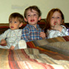 Six kids in a bed.