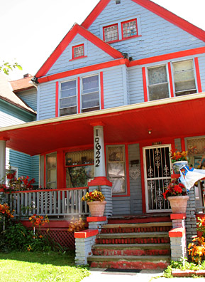 
                    This house on Kimberley Street in Cleveland's Glenville neighborhood is where Superman co-creator Jerry Siegel lived with his family and created the famous cartoon character. A 19-year-old Siegel reportedly couldn't sleep one summer night in 1934 and mulled over different ideas for a Superman character. In the morning, Siegel ran about 10 blocks to his friend Joe Shuster's apartment with ideas he'd written down on bits of paper. Jefferson Gray, the home's current owner, chose to paint it blue and red, Superman's colors. He says he's a fan, too.
                                            (Mhari Saito)
                                        