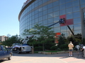 Workers wrap the facade of the Xcel Center