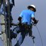 Linemen fix an electrical post