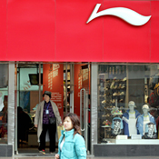 A woman walks past a Li Ning store 