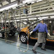 A Nissan Motor employee on an assembly line 