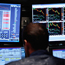 A trader at his computer at the NYSE