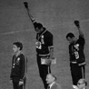 Tommie Smith (center) and John Carlos (right)