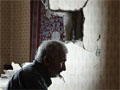 Georgians in a house destroyed by a Russian bomb.