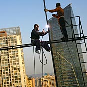 Workers welding on building in China. 