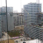 A residential complex designed by Steven Holl Architects is under construction in Beijing. It includes 750 luxury apartments, a movie theater and a school. The towers of the complex are linked by bridges at the top floors.