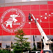 Worker hangs a Republican convention banner. 