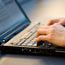 Typing on a laptop