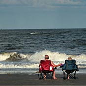 A couple watch waves crash at Tybee Island, Ga. 