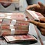 Chinese 100 yuan notes counted at Shanghai bank
