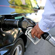A motorist pumps gasoline into his car 
