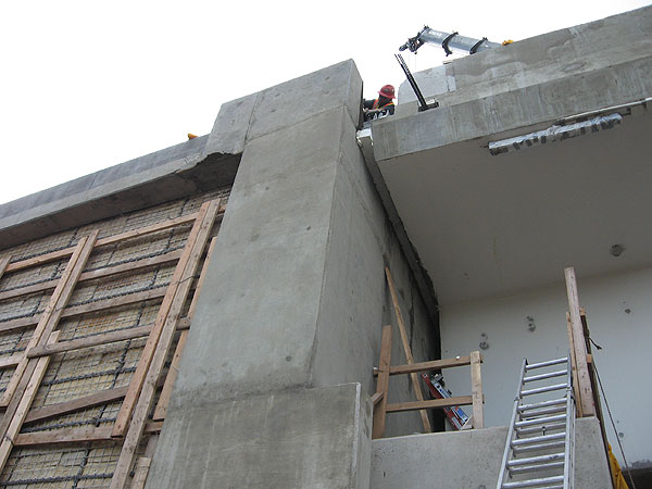 A worker installing expansion joints that allow the concrete bridge to expand and contract with the temperature.
