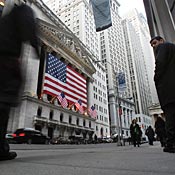 Pedestrians pass the New York Stock Exchange 