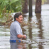 Texas resident wades through high water from Ike.