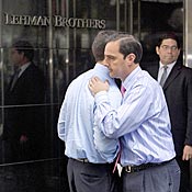 Two men hug outside the Lehman Brothers headquarters building in New York City on Monday.