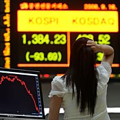 Woman looks at trading board in Seoul 