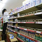 A worker removes melamine-tainted milk powder from the shelves of a supermarket in Beijing. Twenty-two of the 109 milk food firms across China failed tests conducted by the General Administration of Quality Supervision, Inspection and Quarantine (AQSIQ) over the past week. All the melamine-tainted batches have been recalled and will be destroyed, acoording to the AQSIQ.