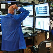 A trader works on the floor of the NYSE 