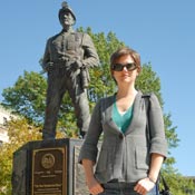 Amy Scott stands near the coal miner statue at the capitol building in Charleston, W. Va.