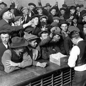 Unemployed men vying for jobs during Depression 