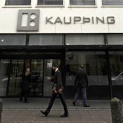 Man walks past Icelandic bank Kaupthing 