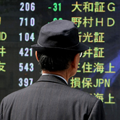 Man at a stockboard in Tokyo 
