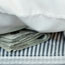 Stuffing money in the mattress