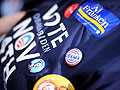 A supporter shows her buttons at the rally
