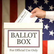Hand putting ballot in voting box. 