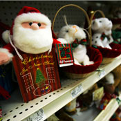 A Santa Claus toy is displayed on a shelf. 