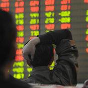 Investors sit in front of stock index in China 