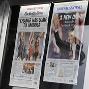 Newspaper front pages with Obama win heads 