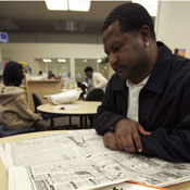 Man looks at job ads in newspaper 