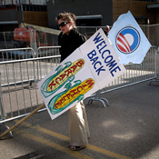 Obama campaign worker holds a welcoming sign 