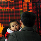 Investor with child views stock prices in China 