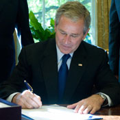President Bush signing a document 