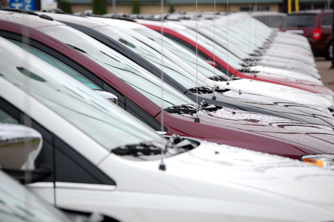 Photo A row of new cars for sale at a Twin Cities auto dealership