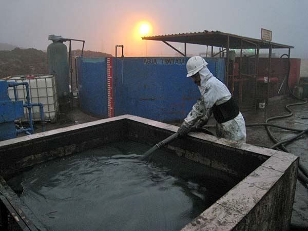 
                An Ecolimpio employee treats sludge in the light of dusk.
                                    (Dan Grech /  Marketplace)
                                