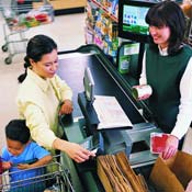 Woman uses food-stamp card at grocery store 