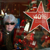 woman  reflected in a holiday Macy's window 